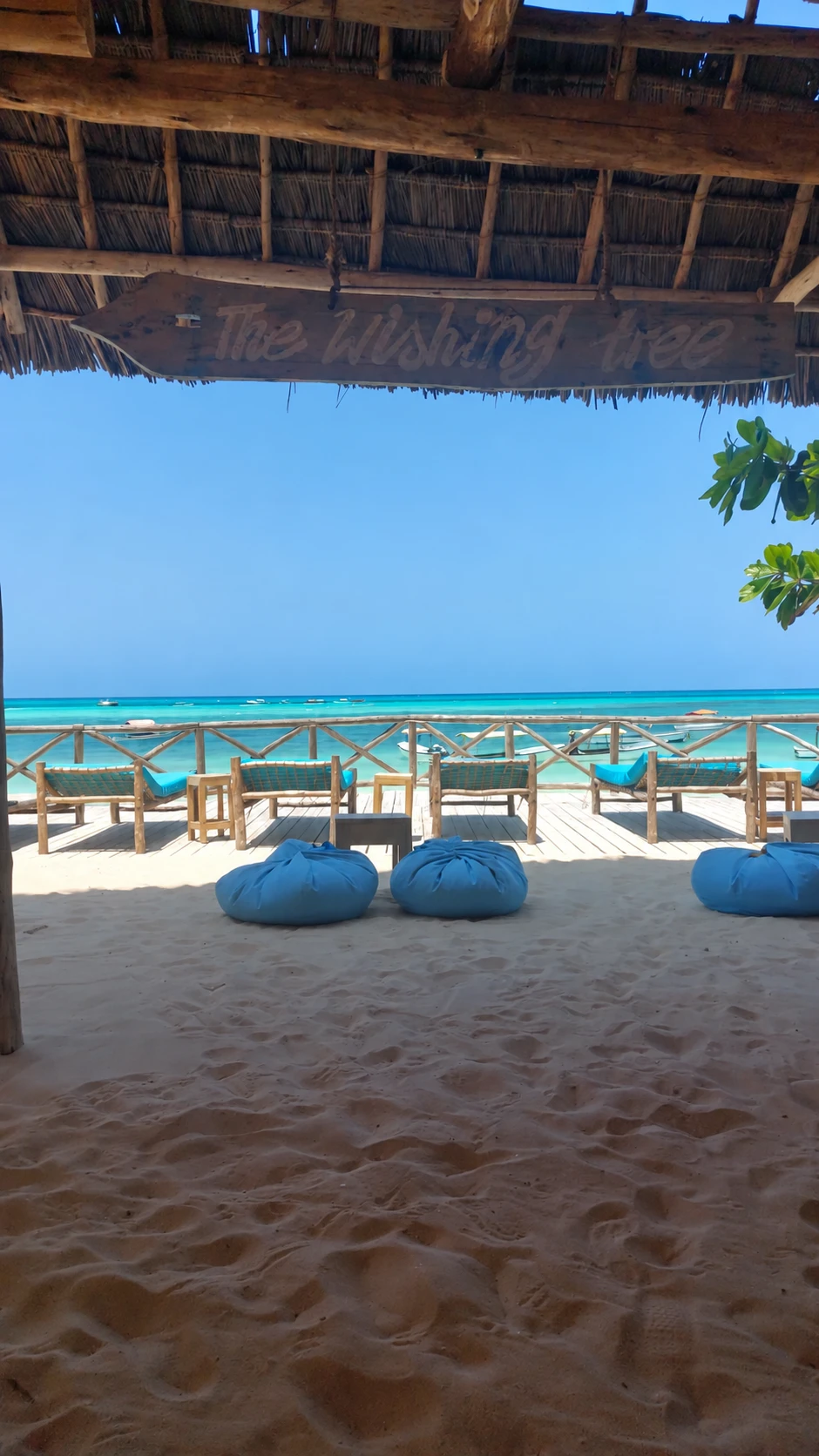 Oceanfront tables and turquoise water at The Wishing Tree